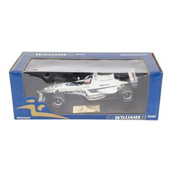 Three signed limited edition 1:18 scale Formula One models, comprising Hot Wheels Jordan EJ12 signed by Takuma Sato, Hot Wheels Jaguar Racing R2 signed by Eddie Irvine and a Minichamps Williams F1 Team model signed by Jenson Button, 1:18 scale model, all boxed