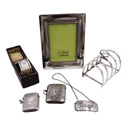 Group of silver, comprising rectangular photograph frame, hallmarked Mappin & Webb Ltd, Sheffield 2006, small 1930s five bar toast rack, hallmarked Barker Brothers Silver Ltd, Birmingham 1930, together with two vesta cases, 'Sherry' decanter label and a napkin ring in fitted case, all hallmarked 
