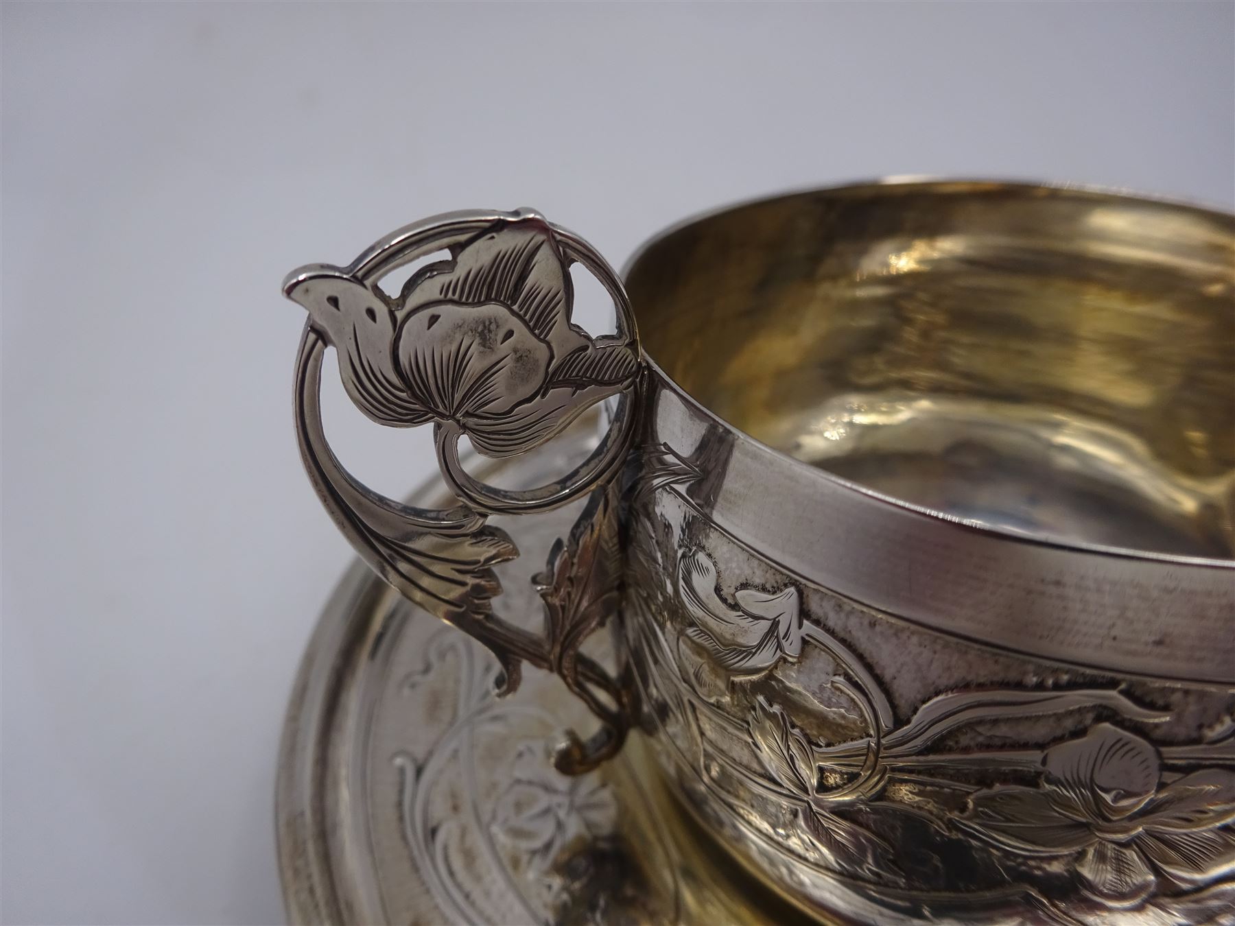 French silver cup and saucer, with embossed floral decoration throughout and openwork floral handle, stamped with Minerva's head and maker's mark for 	P. Fres Paris, cup H5.5cm