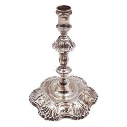 George II cast silver candlestick, with fluted knopped column upon a hexafoil foot, engraved with stag crest, hallmarked London 1750, maker's mark worn and indistinct, H13cm