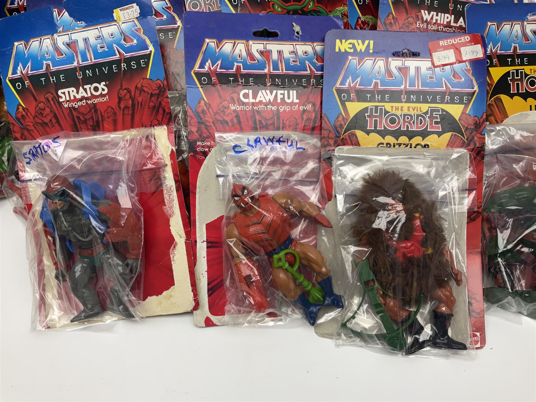 Thirty-one Masters of the Universe He-Man figures re-bagged on original backing cards;  two others lacking backing cards; boxed Modulok figure; bag of weapons and accessories; Roton, two horses and two battle cats; 1986 & 1987 Annuals; Ladybird and other story books; Panini sticker album; instructions etc
