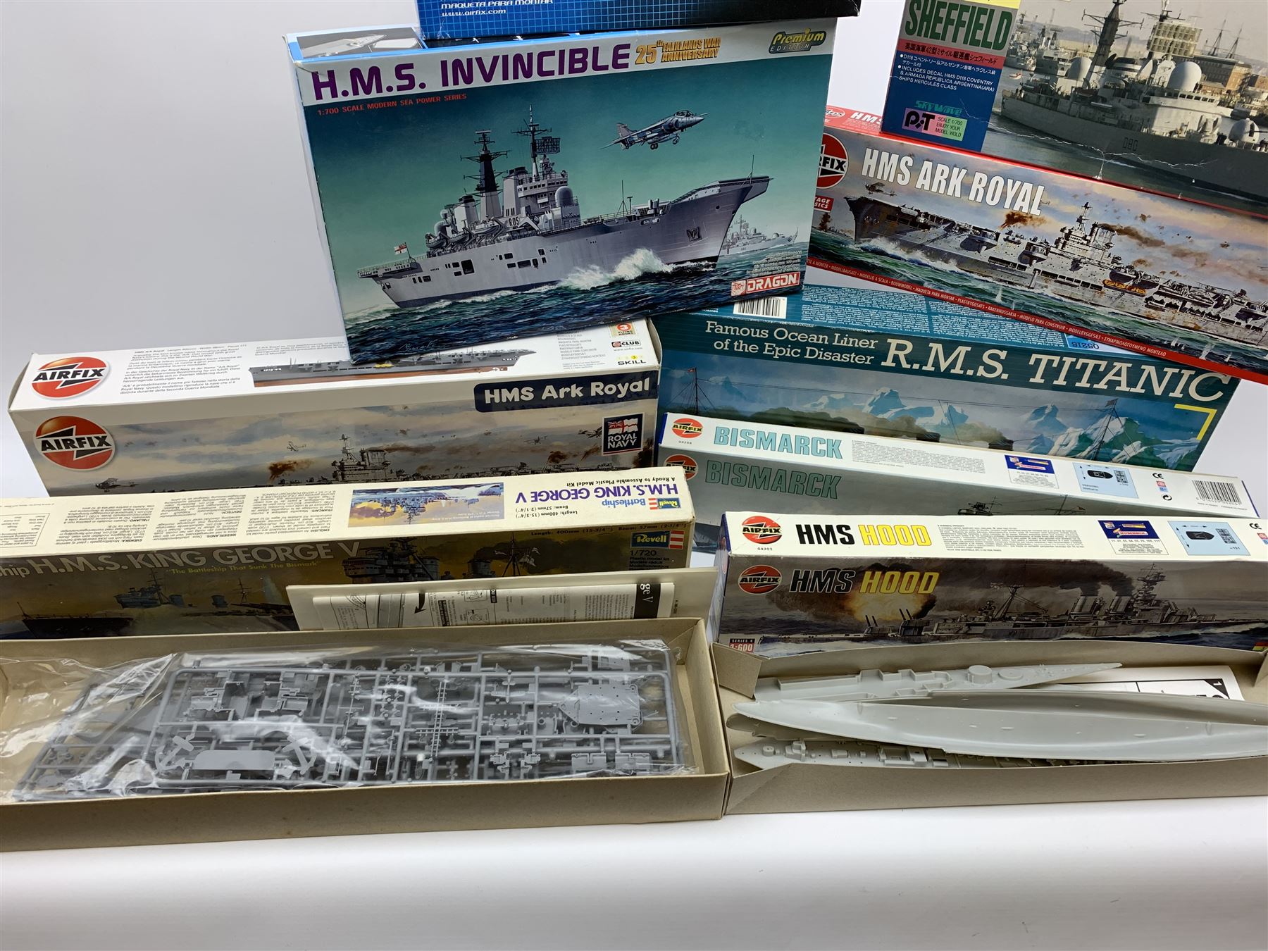 Ten plastic model kits of ships by Airfix, Revell, Dragon and Skywave, predominantly 1/600th scale including R.M.S. Titanic, HMS Invincible, two x HMS Ark Royal, HMS Fearless, HMS Hood, HMS Belfast, Bismarck etc; all boxed, most in factory sealed transparent packaging (10)