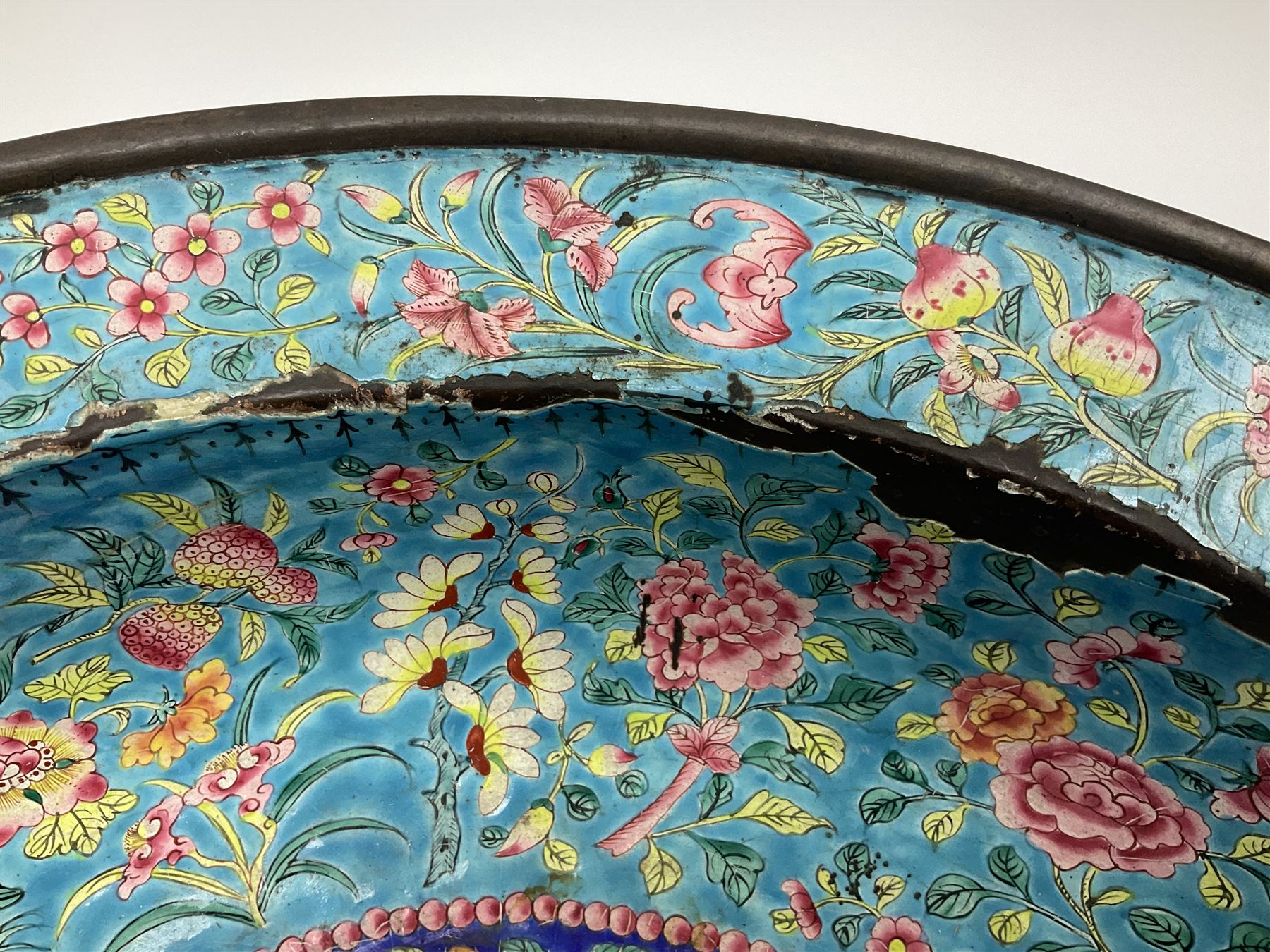 18th/19th century Chinese Canton enamel basin, the circular basin with flat everted rim, decorated with scrolling foliate and fruit decoration on a blue ground, D43cm