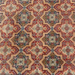 Central Persian Kirman carpet, the field arranged with alternating indigo star shaped and red cruciform compartments, each filled with rosettes, flowerheads and scrolling foliage, enclosed by a broad ivory palmette border and red floral guard bands