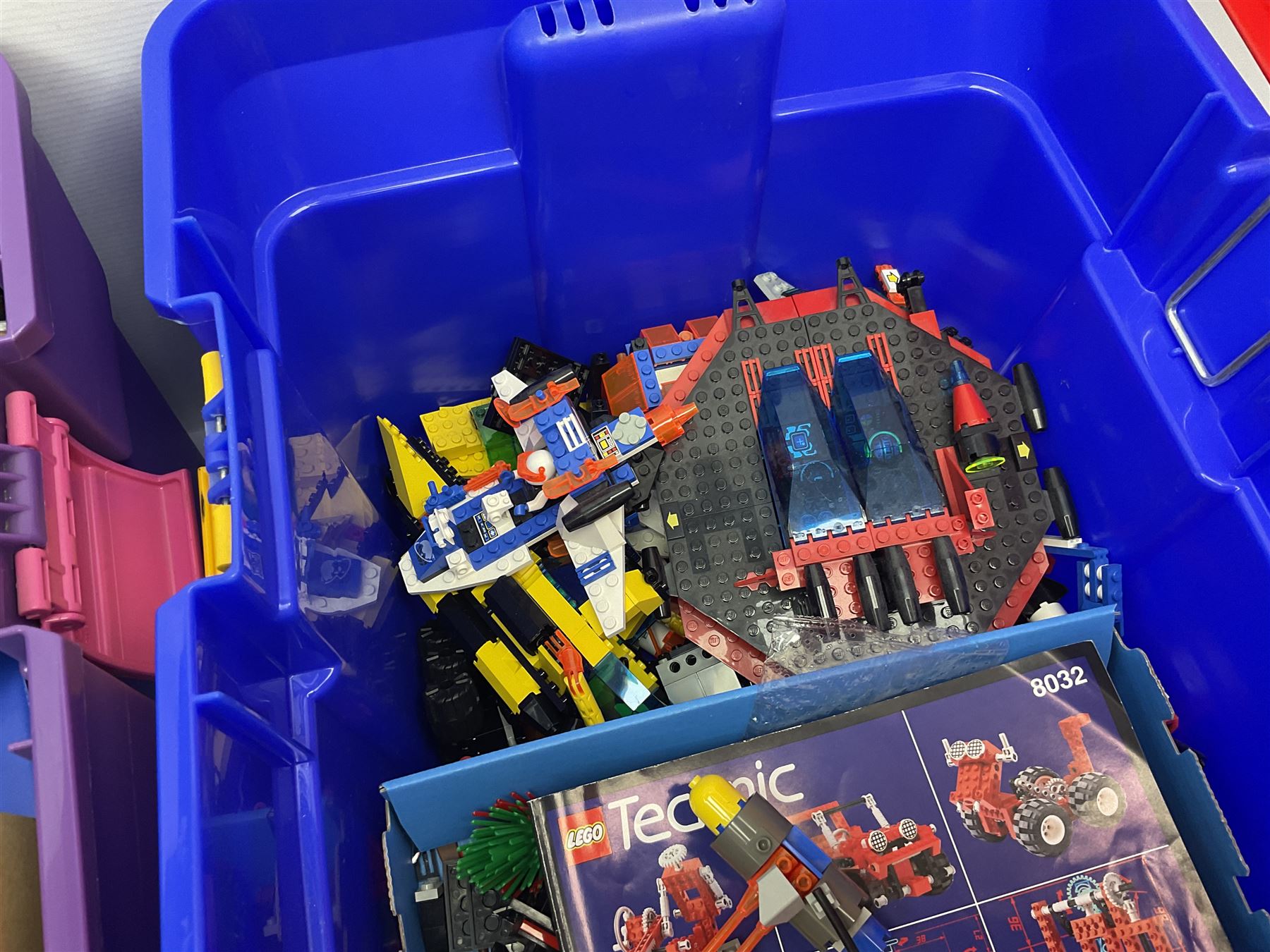Lego - large quantity of part-built models and loose component parts including Lego Technic and Lego System, space and road vehicles, ships and boats, helicopter etc; together with two set boxes and folder  containing large quantity of instruction booklets; stored in two very large plastic boxes
