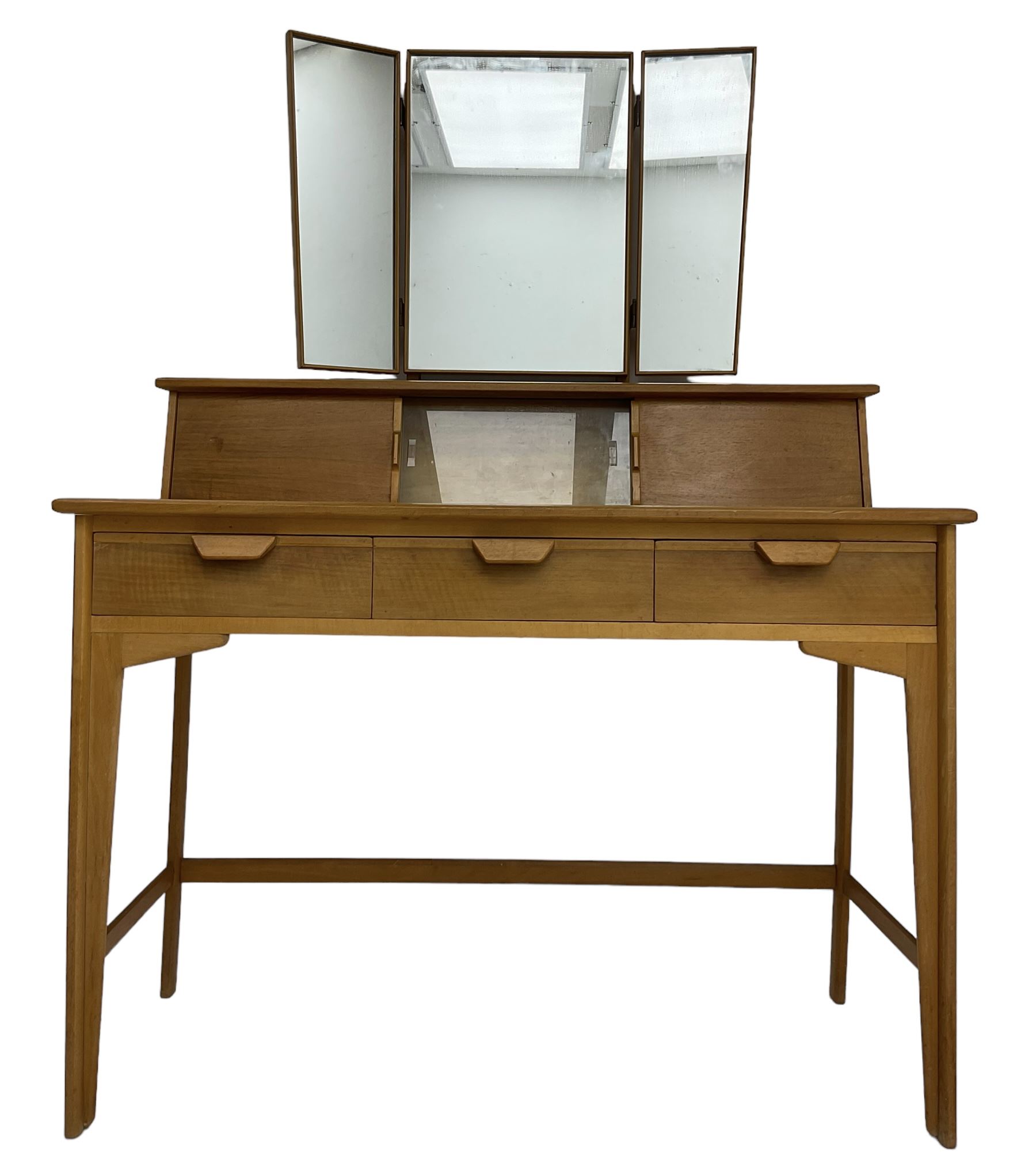 Heals of London - 1950s walnut and beech dressing table, raised triple mirror back over trinket compartments enclosed by sliding doors, above three drawers, on tapering supports