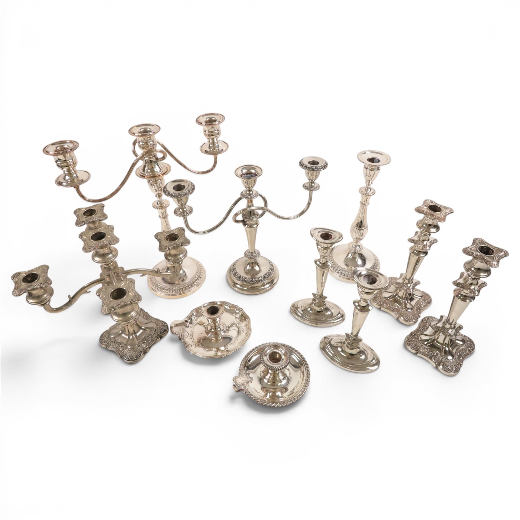 Silver plate two branch candelabra with grape vine decoration to the base, together with a matching pair of candle sticks and other candlesticks  