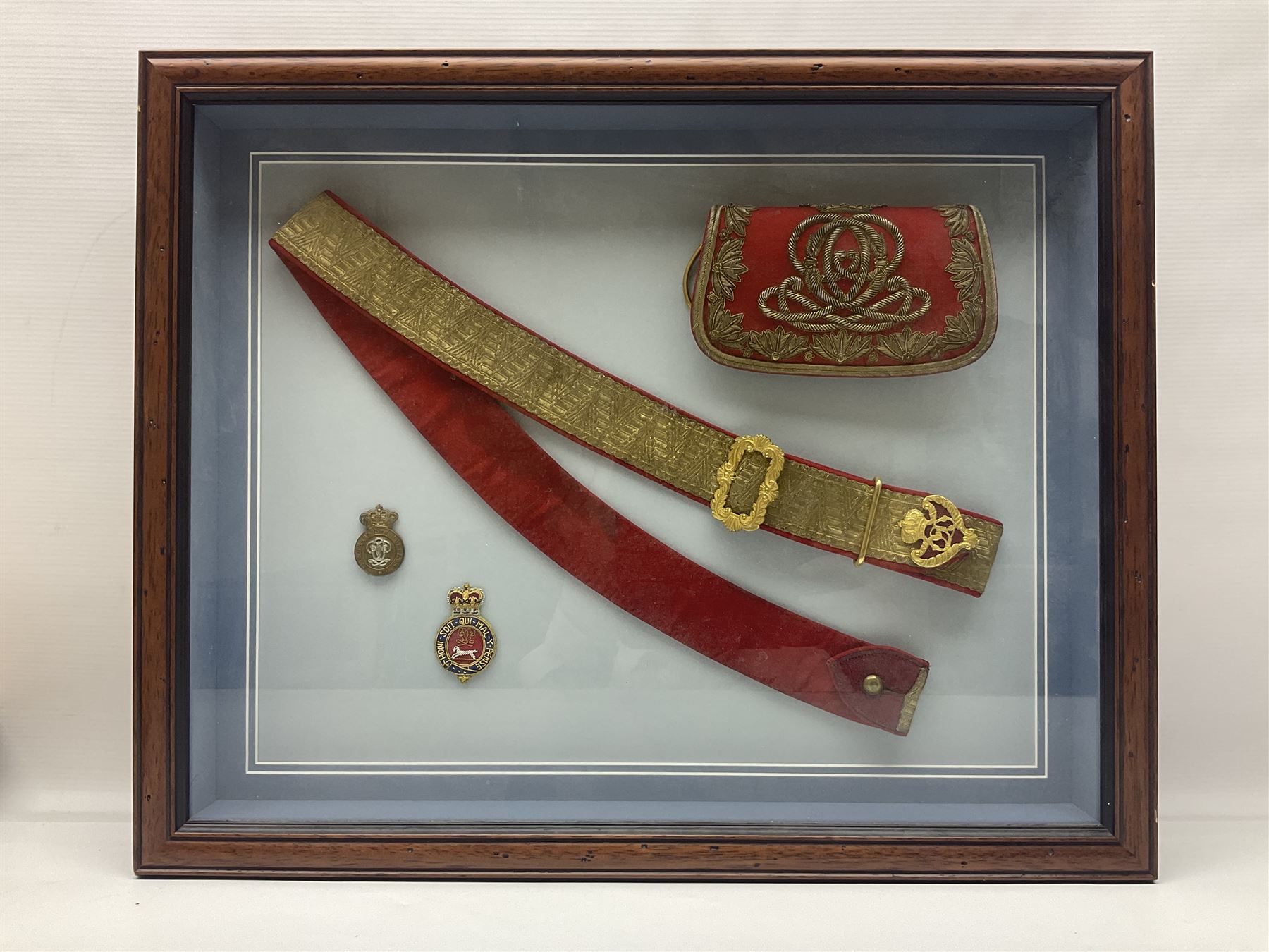 Victorian / Edward VII Queens Own Hussars Officers Full Dress Pouch and Cross Belt; scarlet cloth covered leather pouch with bullion embroidered crown, laurel bordered regimental crest within an edge of embroidered bullion wire; with its original officers cross belt with fine regimental pattern brocade to the top and gilt metal furniture; displayed in a wall hanging case with cloth and metal regimental badges; mahogany stained frame 44 x 54cm