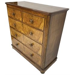 Early 20th century figured walnut chest, fitted with two short over three long drawers with bookmatch veneer facias, each with turned walnut handles, skirted base over compressed bun feet 