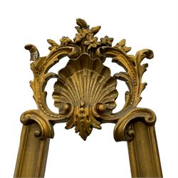 Early 20th century giltwood and gesso floor standing picture easel, the shell pediment surrounded by acanthus leaves and surmounted by flower heads, supported upon a moulded frame with shell and foliate moulded middle rail, the terminals decorated with acanthus leaves and scrolls 