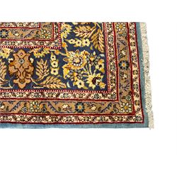 Central Persian Qum pale blue ground rug, the field decorated with stylised plant motifs surrounded by trailing foliate vine patterns in a symmetrical format, the multi-band guarded indigo border decorated with repeating flowerheads 