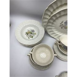 Royal Doulton dinner wares decorated in the Sutherland pattern, comprising two serving platters, one tureen and cover, six twin handled soup bowls and saucers, eight bowls, six dinner plates, seven side plates, and jug. 