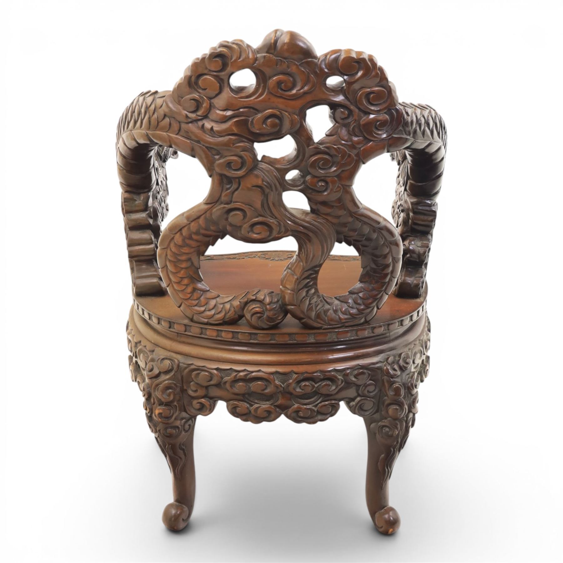 Chinese carved hardwood dragon throne chair, the shaped and pierced back with entwined dragons and cloud motifs, sweeping dragon-form arms terminating in carved heads, solid panel seat over foliate carved apron, on four mask carved cabriole supports