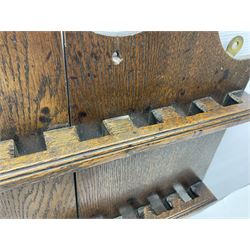 George III oak spoon rack and candle box, the rectangular backplate with shaped  pediment and two six aperture spoon racks, above a candlebox with hinged cover, with various brass spoons and a pair of brass candle snuffers, H56.5cm, W35cm, D14cm 