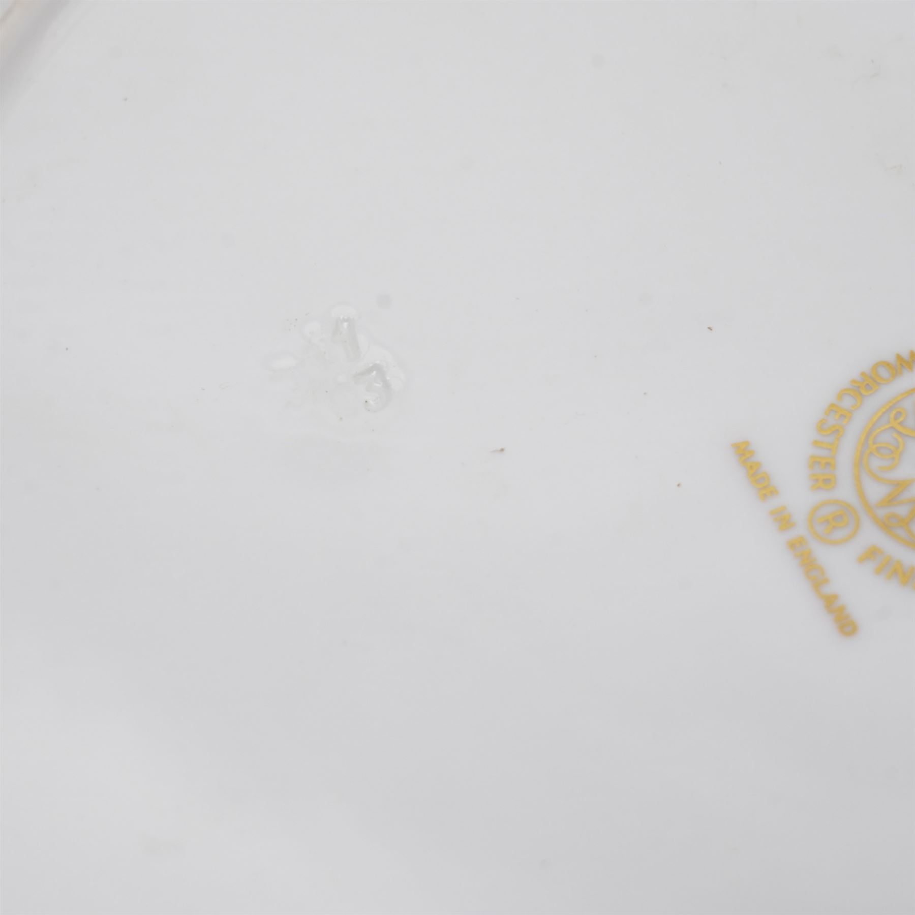 Pair of Royal Worcester cabinet plates painted with central panel of fruit by Peter Platt signed 'P Platt' within a green and gilt surround D27cm