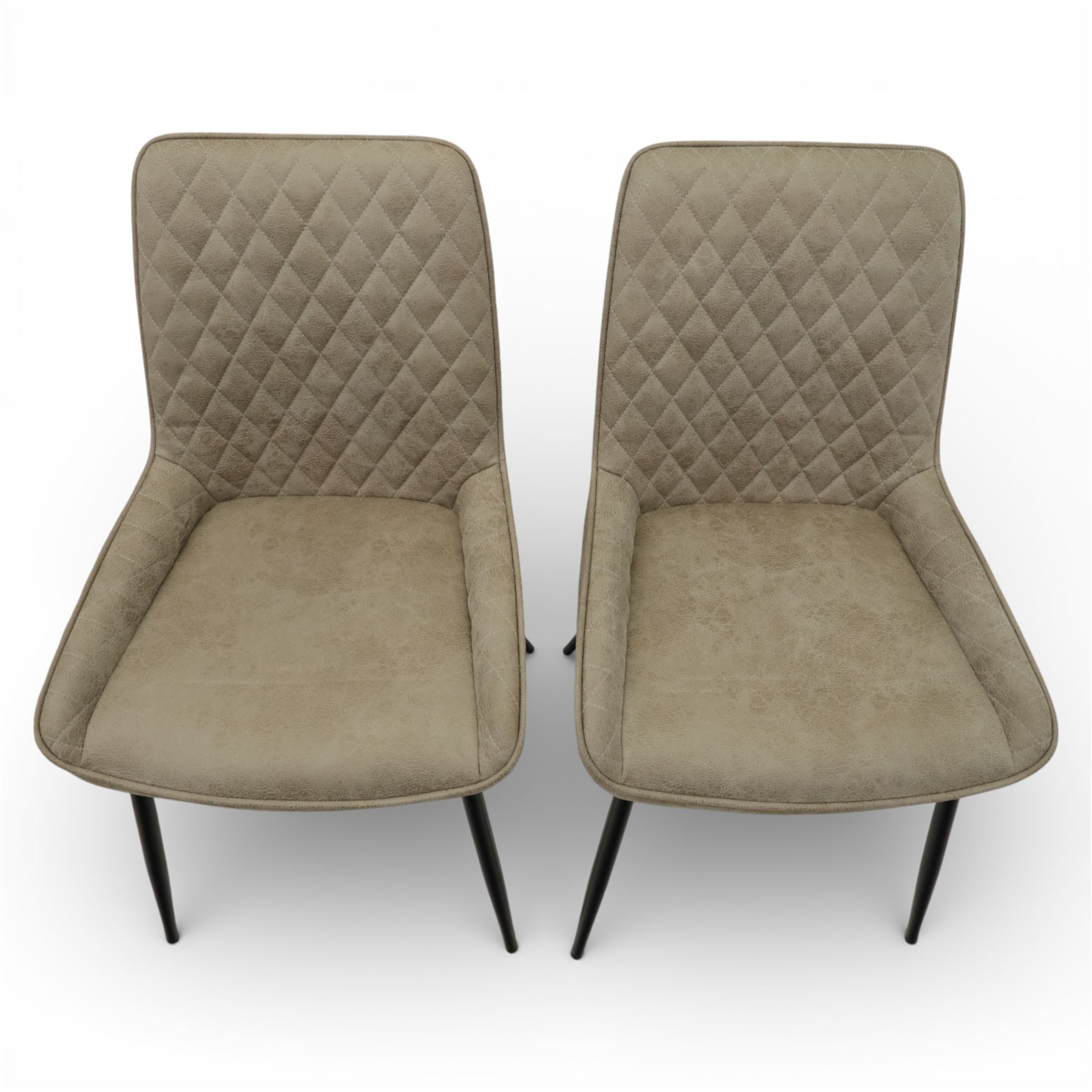Next Home - ‘Monza’ design set of four dining chairs, upholstered in mink-toned faux leather with diamond quilted backs and plain padded seats, shaped backs with integrated side wings, raised on black painted tapering metal supports