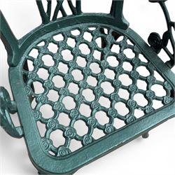 Cast aluminium oval garden table and set of four armchairs with pierced rose design back splats