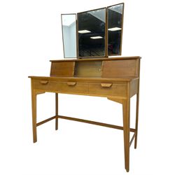 Heals of London - 1950s walnut and beech dressing table, raised triple mirror back over trinket compartments enclosed by sliding doors, above three drawers, on tapering supports