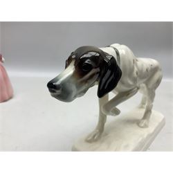 Early 20th century Katzhütte figure of a pointer dog, and figure of a young girl holding basket and fan, both with green cat H house printed mark beneath, dog L25cm