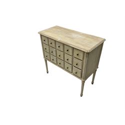 Washed finish pigeon hole or apothecary style chest, fitted with fifteen drawers, raised on fluted tapered supports 