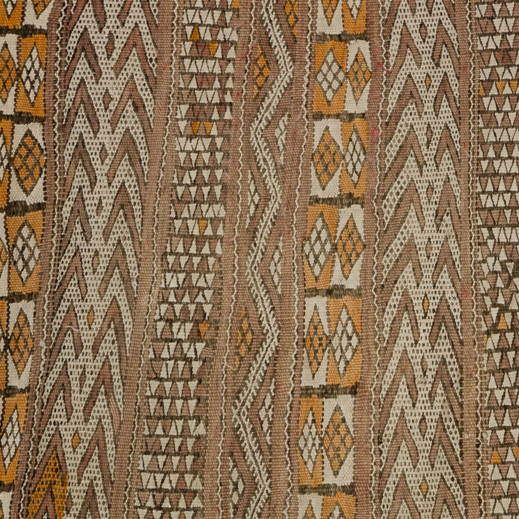Berber style mid 20th century flat-weave kilim, woven is alternating horizontal bands of hooked lozenges, diamonds, and chevron motifs in a terracotta, ochre, ivory, and brown palette, framed by narrow geometric borders  