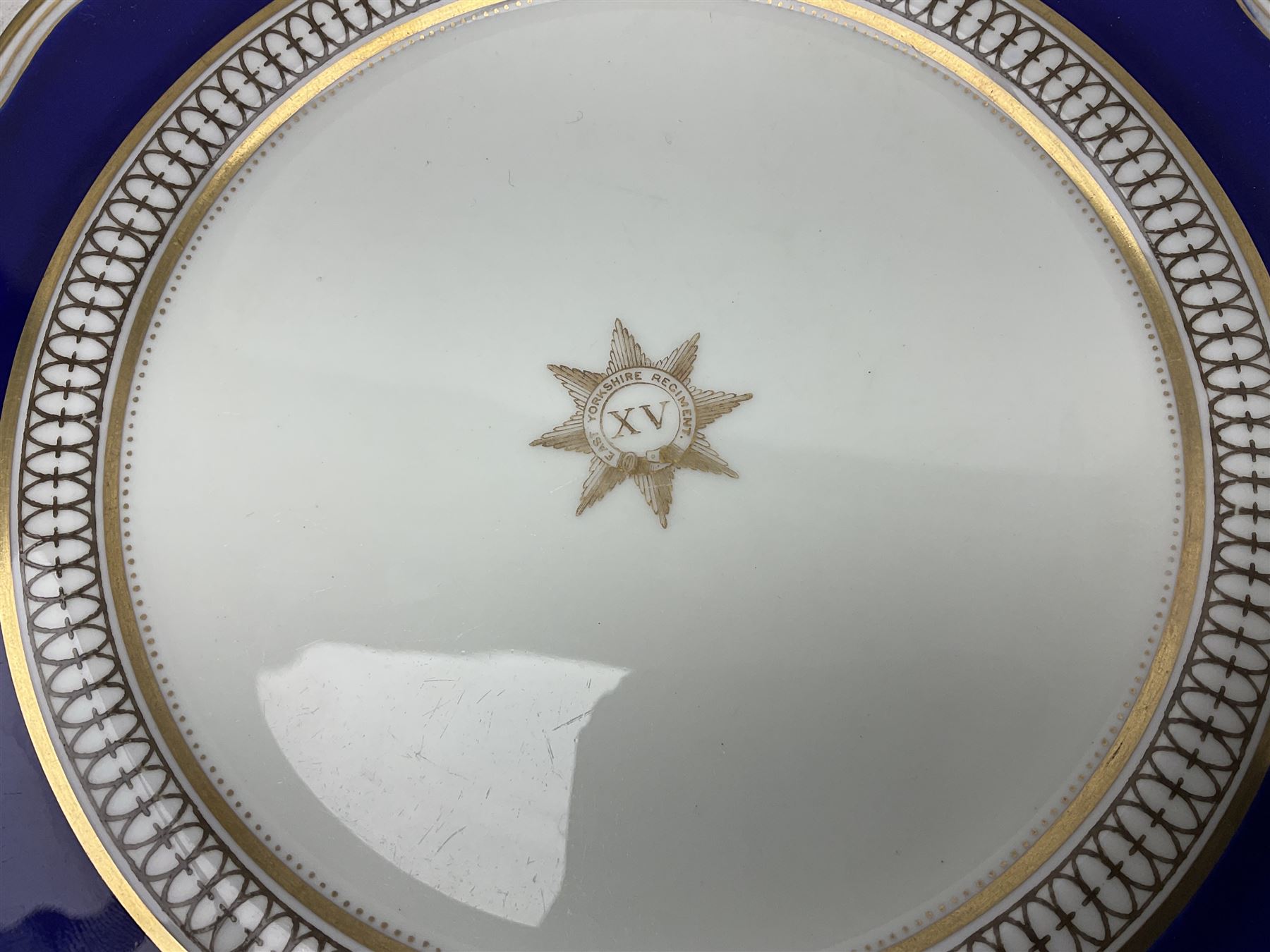Collection of Regimental dinner wares, Comprising Royal Sussex; two dinner plates, two side plates and a soup bowl, Royal Leicestershire; two dinner plates, East Yorkshire Regiment side plate and Gordon Highlanders side plate, all decorated with the regiment's crests and blue and gilt boarders (9)