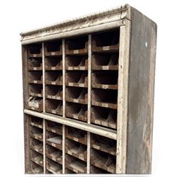 F Pollard & Co - late 19th century rustic haberdashery shop cabinet, fitted with an assortment of forty sliding trays, with drawers fitted to base, in antique white-painted finish