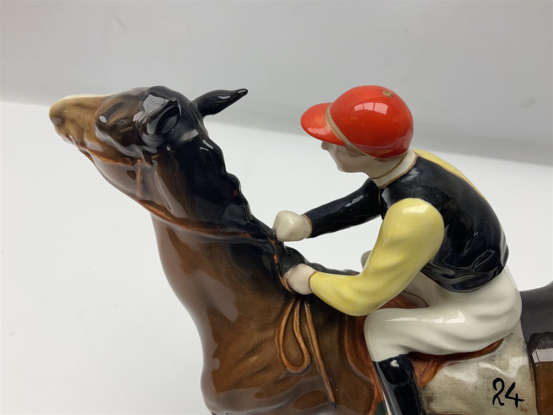 Beswick jockey on walking horse no 1037, in black white and yellow jockey colours, with printed mark beneath, H22cm