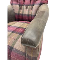 John Sankey - low armchair, buttoned back upholstered in tartan patterned fabric with contrasting grey leather, raised on turned and ebonised front feet with brass and ceramic castors, with matching foot stool
