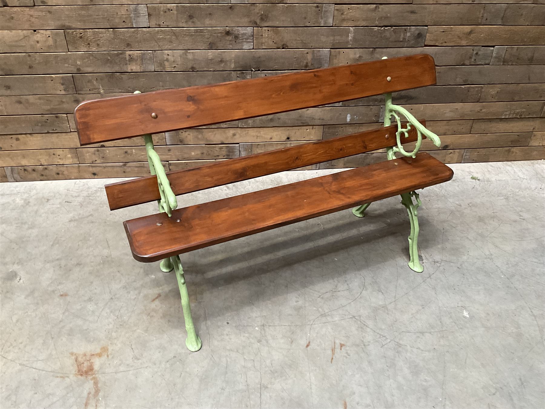 Cast iron and wood slate bench painted in green