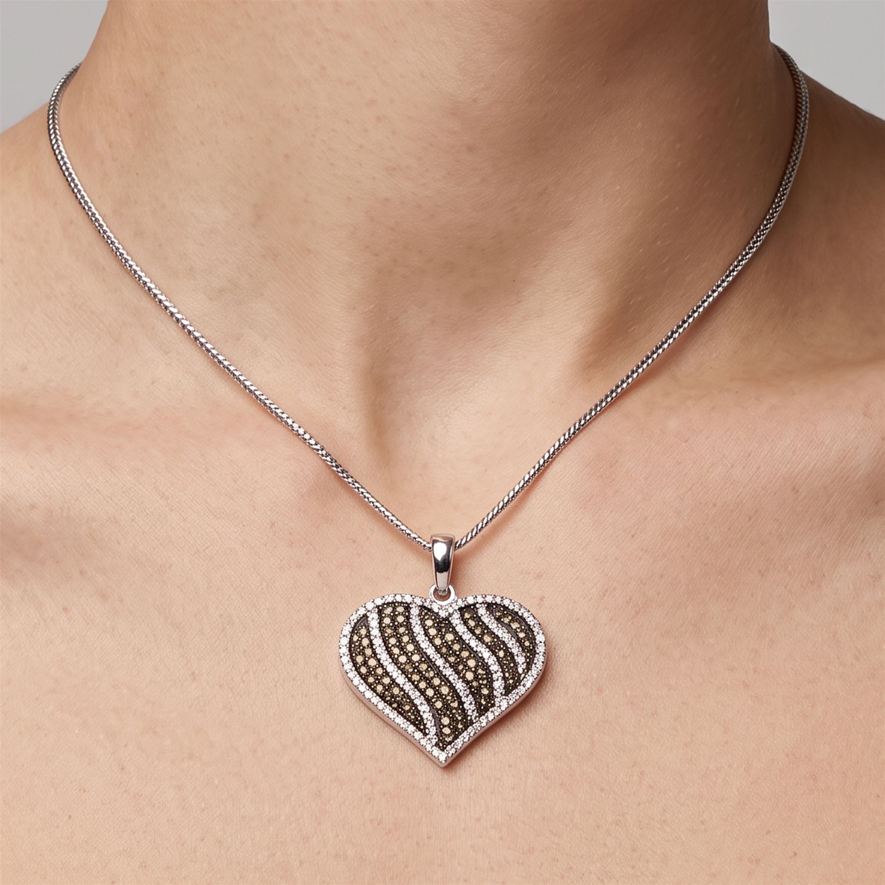 9ct white gold diamond heart pendant necklace, set with rows of round cut fancy light brown and white diamonds, hallmarked, total light brown diamond weight approx 0.75 carat, total white diamond weight approx 0.75 carat