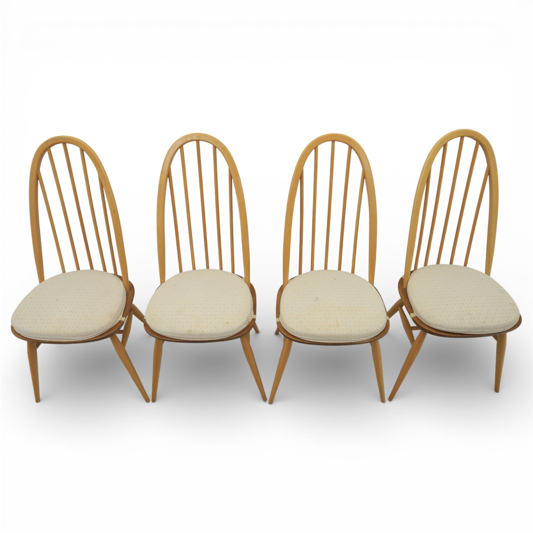 Ercol - elm dining chairs, set of six including two armchairs, arched spindle backs over shaped elm seats with upholstered pads, tapering beech legs joined by stretchers