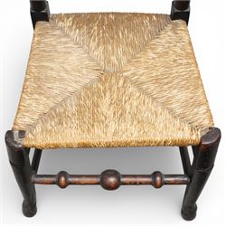 Set of five 19th century elm spindle back chairs, with shaped crest rails above double rows of turned spindles, rush seats, turned legs joined by stretchers supported on turned pad feet