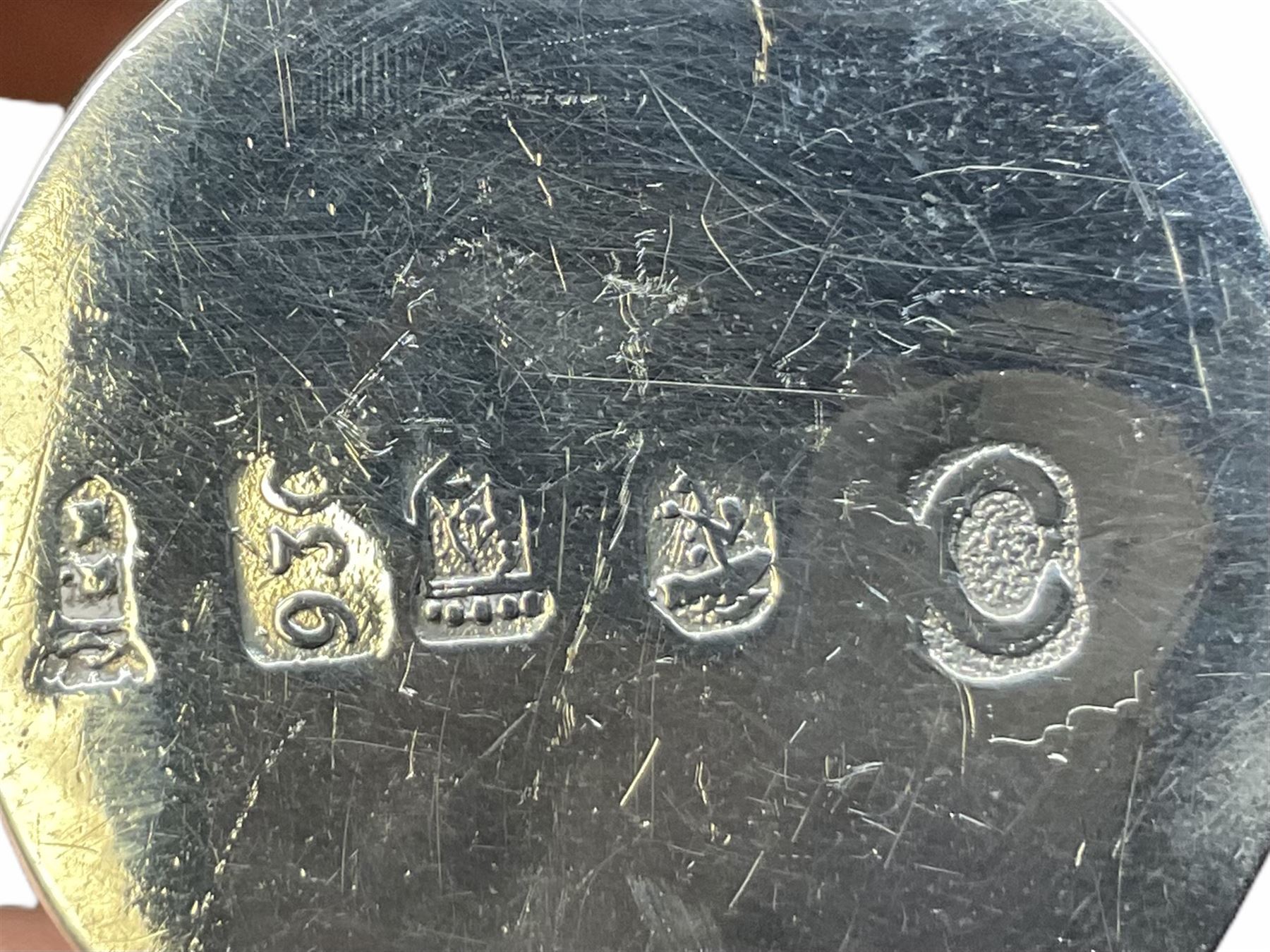 Cut glass perfume bottle of bellied form, the silver mounted cover with turquoise guilloche enamel top, hallmarked Henry Perkins & Sons, London 1927, together with a cut glass perfume bottle with silver mounted and yellow guilloche enamel lid, hallmarked Albert Carter, Birmingham 1950, Continental silver perfume bottle, of barrel form with embossed figural detail, stamped 930, scent bottle of bellied form with white metal foliate pierced overlay, amethyst glass scent bottle of flask form with foliate embossed white metal cover and suspension ring and chain, and three further examples, including one of ovoid form with painted decoration and silver cover, hallmarked for Birmingham.