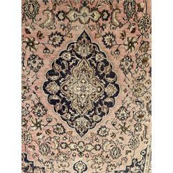 Persian Kashan carpet, blue shaped medallions and spandrels, the field decorated with interlacing branch and stylised plant motifs, repeating floral design borders