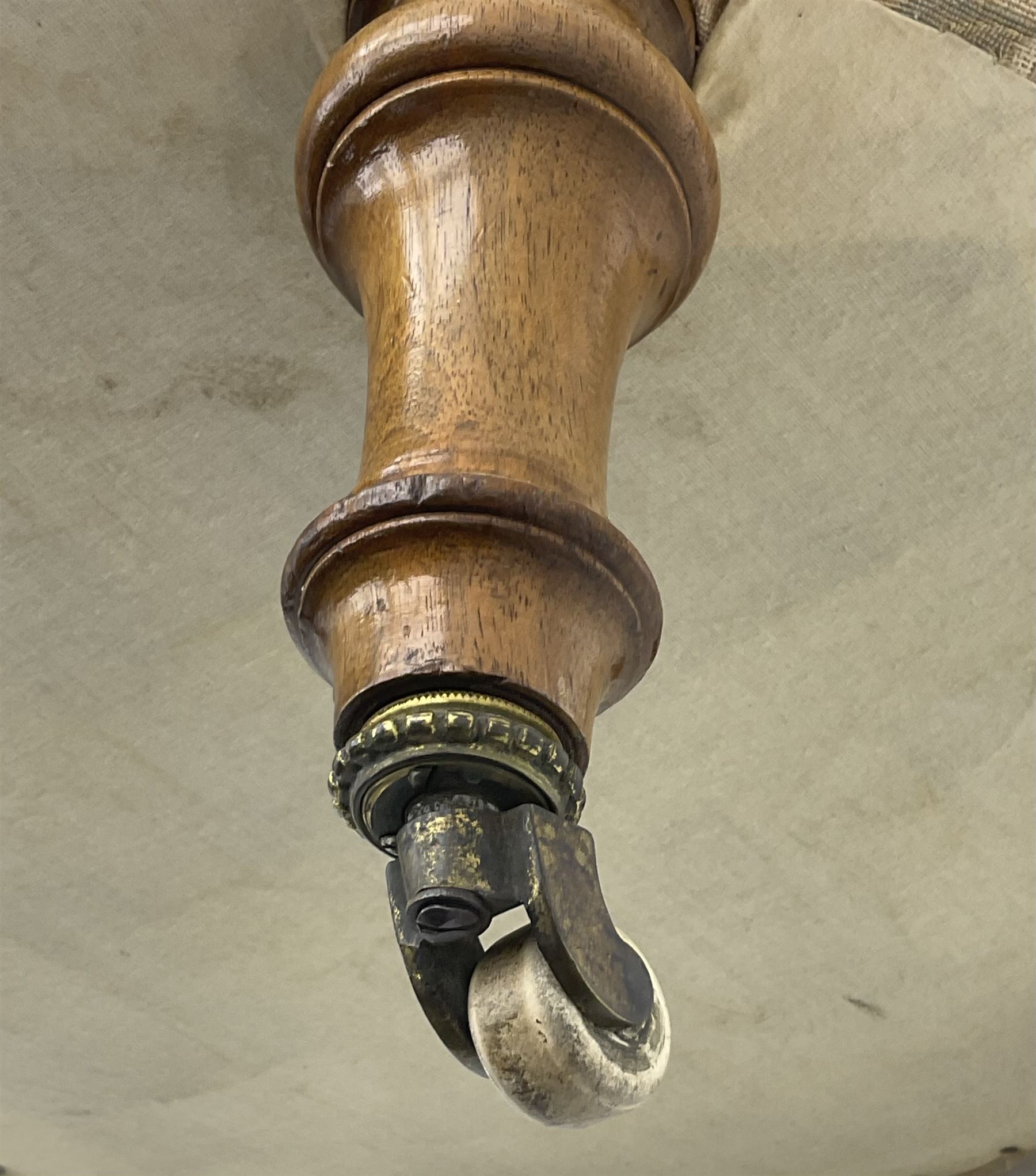 Victorian walnut framed nursing chair, upholstered in buttoned floral pattern fabric, on turned front feet 