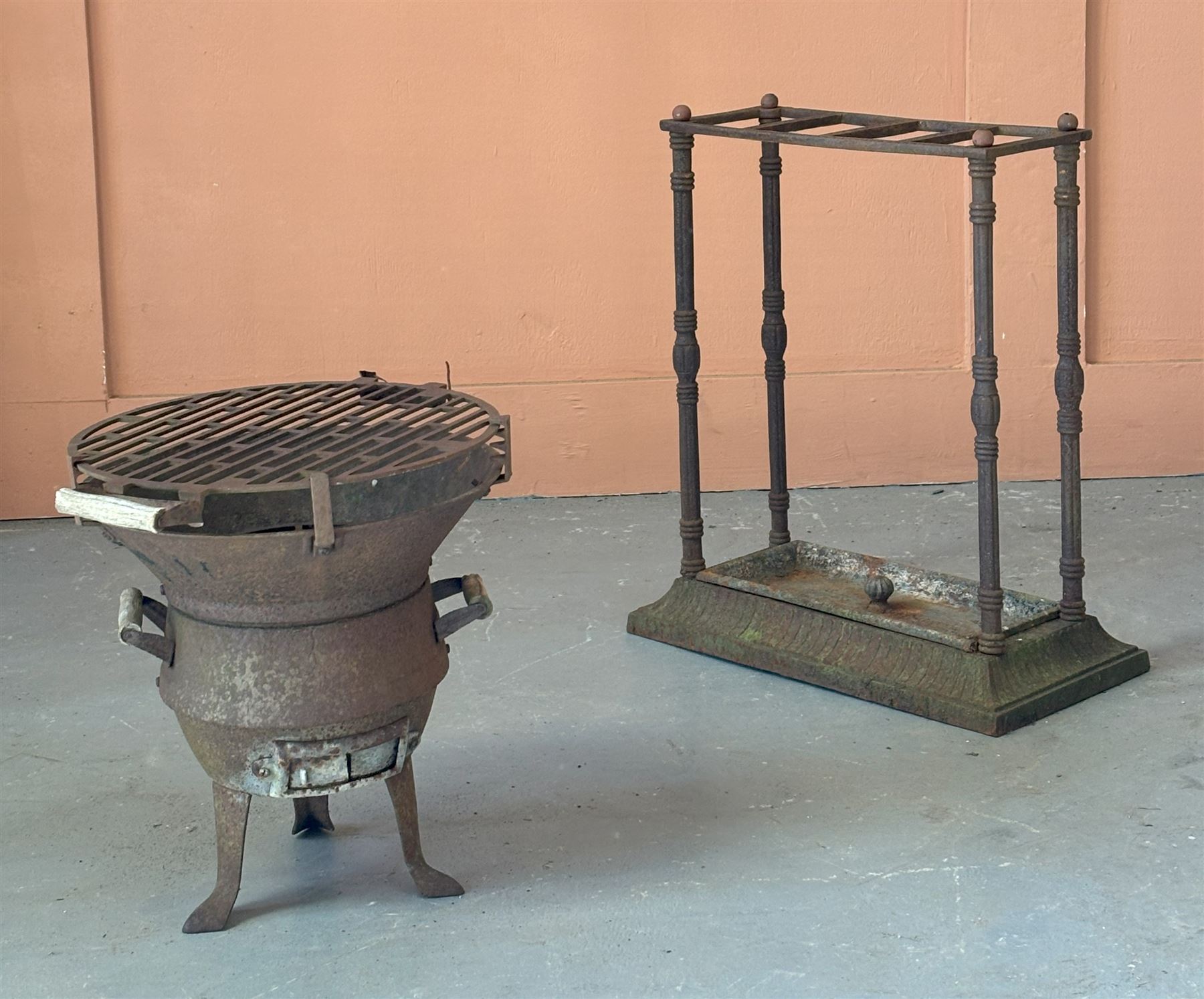 Victorian cast iron stick stand, three divisions raised on reeded columns, over a rectangular base with drip tray (H59cm, W50cm, D26cm) together with a cast iron patio stove on tripod supports. (H41cm) (2) - COLLECTION BY APPOINTMENT FROM: The White House, Thirsk Road, Easingwold, York, YO61 3NF - CALL 01723 507111 TO ARRANGE