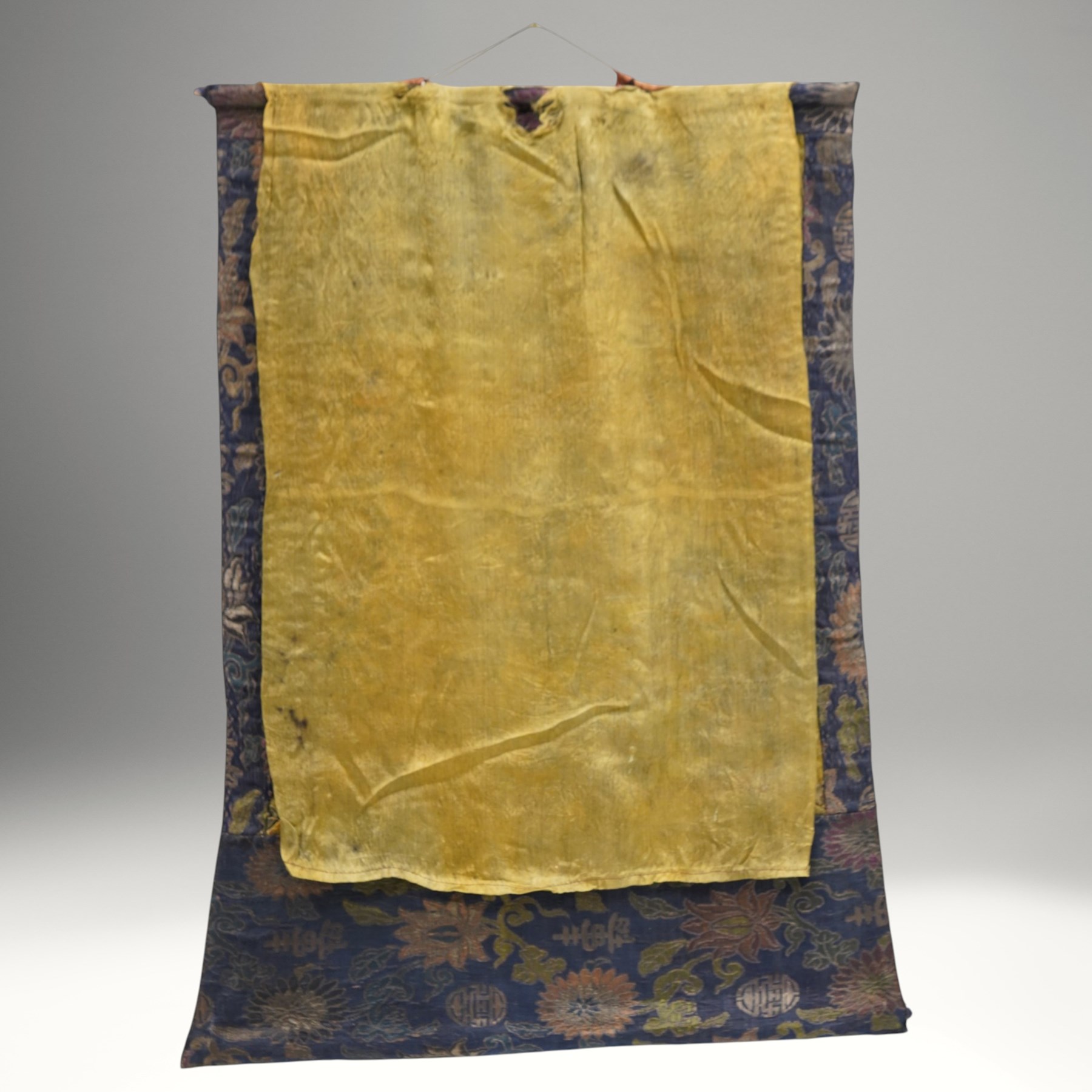 Two 19th century Tibetan Thangkas, depicting Bhavachakra or the Wheel of Life, and the other depicting a Buddhist mandala, each mounted on brocaded fabric, image sizes 64cm x 46cm and 62cm x 47cm (2)