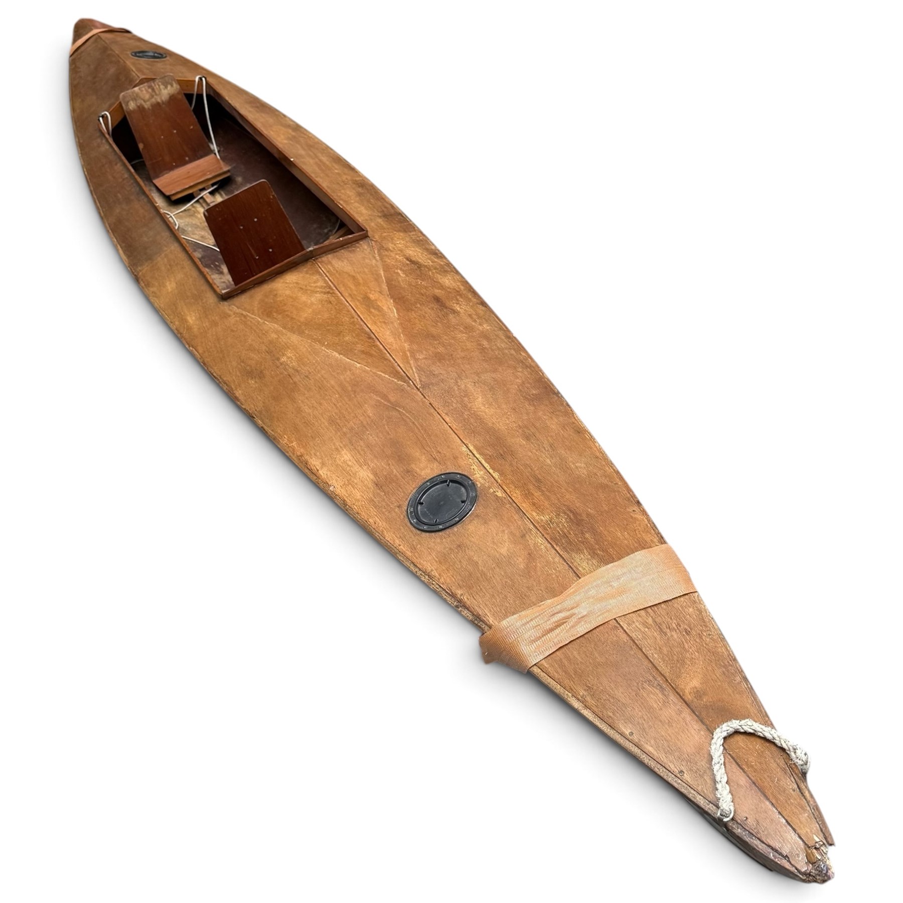 Mid-20th century varnished marine plywood two-person touring kayak, the decked hull with pointed bow and stern, two circular Holt-Allen access hatches and central open cockpit fitted with seats