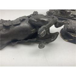 Spanish carved figure of Don Quixote, holding a book, base stamped 'Ouro, together with two spelter figures and one other