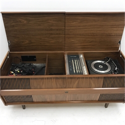  HMV 2354 teak cased stereogram, two hinged lids enclosing a Garrard 3000 record player and radio, square tapering supports, W143cm, H62cm, D52cm  
