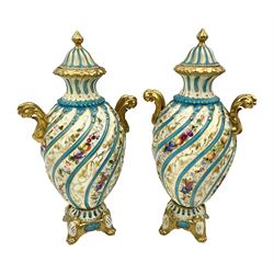 Pair of late 19th/early 20th century Sevres style vases and covers, of baluster form with gilt scroll handles and domed covers, the wrythen fluted bodies decorated with alternating bands of painted fruit and flowers and gilt vines, upon a white and celeste blue ground, with printed and impressed marks beneath, H22.5cm 