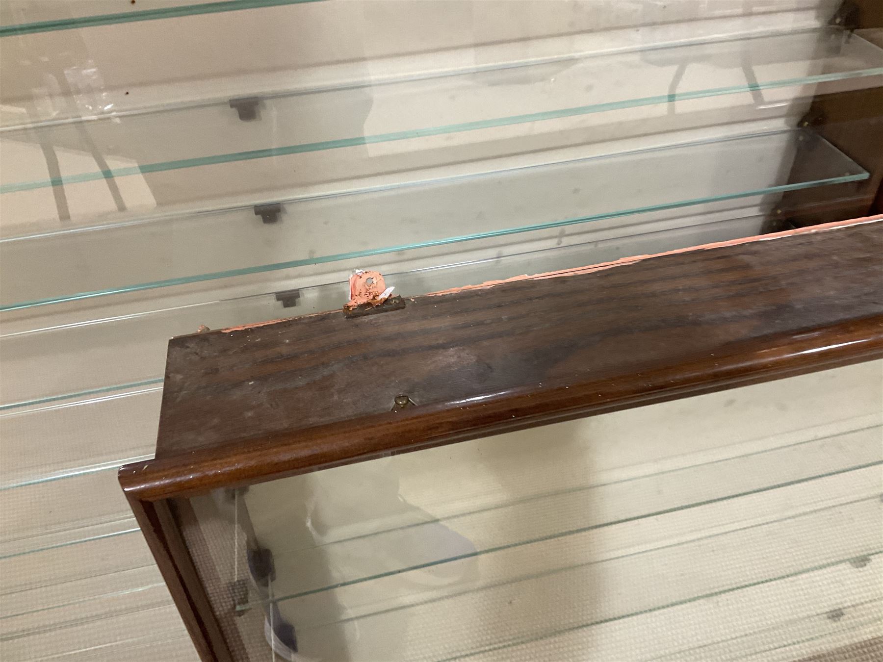 Four die-cast model wall mounting display cases by Picture Pride Displays Sandwell; each with mahogany stained frames and glazed fronts; three 83 x 75.5cm with eleven plate glass shelves and one 57 x 106cm with five plate glass shelves (4)