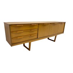 Stonehill Furniture (SF) Ltd - mid-20th century teak sideboard, rectangular topover three drawers, two cupboard doors and fall-front drinks cupboard, raised on square tapering supports