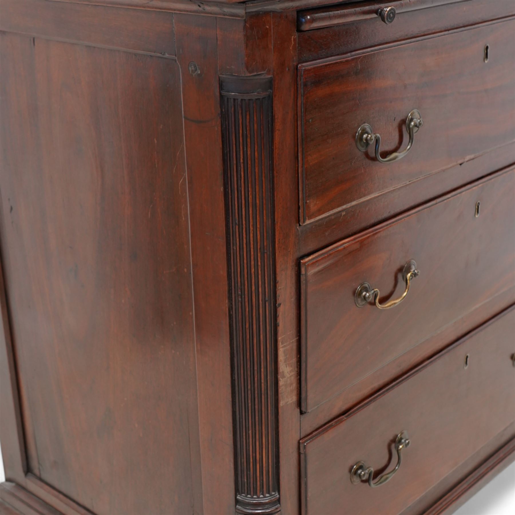 Georgian mahogany bachelor's chest, brushing slide over three long drawers, enclosed by canted corners with fluted quarter columns, on ogee bracket feet