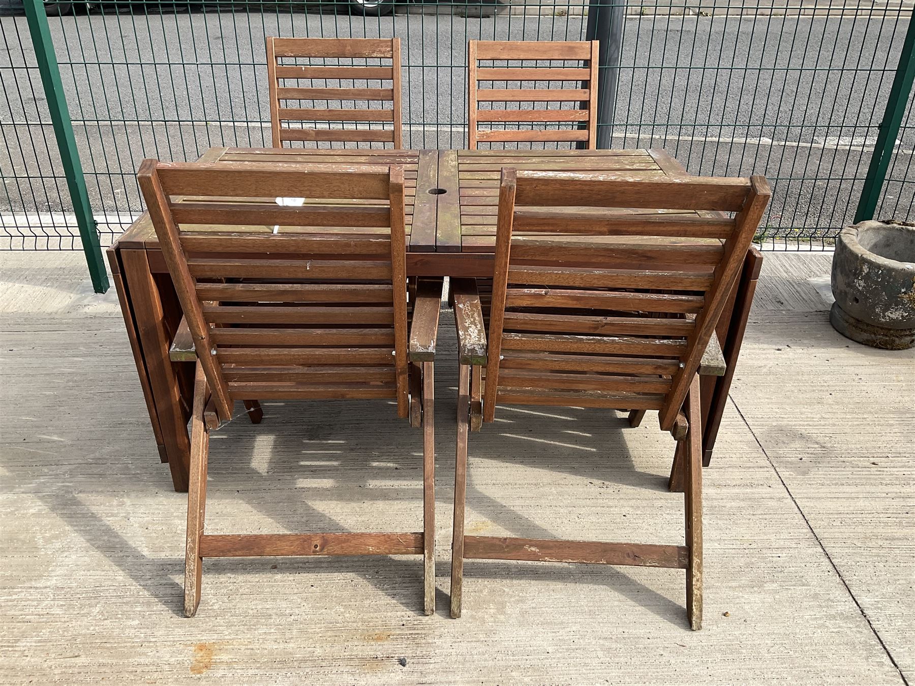 Rectangular teak drop leaf garden table, and four slatted armchairs