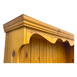 Victorian design pine dresser, projecting moulded cornice over scalloped frieze and two open shelves, base fitted with two drawers over double cupboard, on shaped plinth base