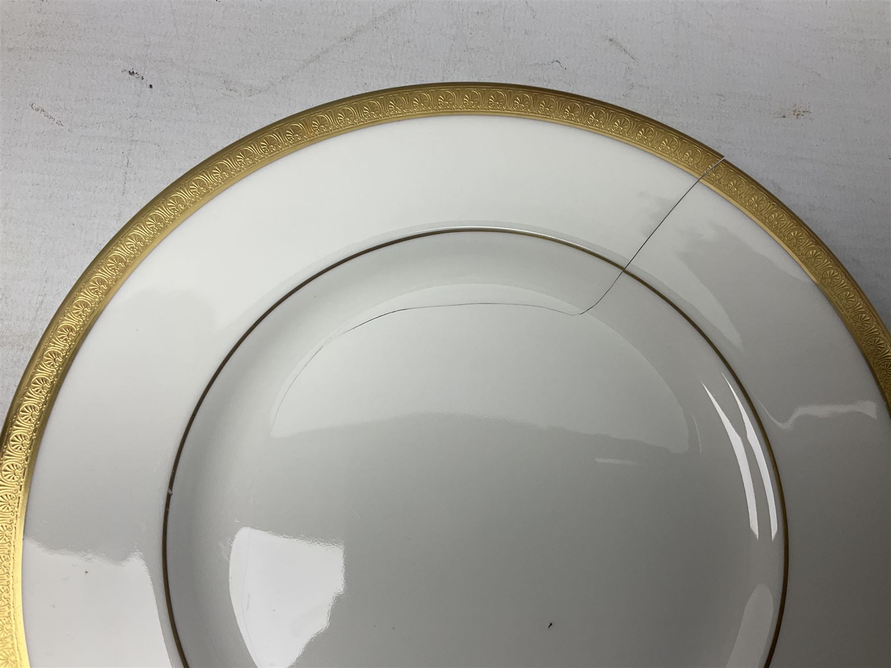 Royal Doulton Royal Gold pattern tea and dinner service for eight, comprising dinner plates, side plates, tea plates, soup bowls, sauce boat and saucer, dessert bowls, coffee cans and saucers, teacups and saucers and two lidded tureens