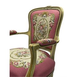 Near pair of French Louis XVI design lacquered hardwood-framed parlour elbow chairs, moulded flower head cresting rail over scrolled arm terminals, back and seat upholstered in prink and fuchsia floral and urn decorated tapestry fabric, on cabriole supports, in craquelure cream finish with painted gilt piping