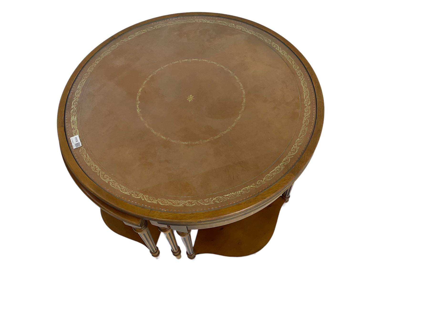 Yew wood circular coffee table with four nesting tables, inset leather and glass tops, on turned and fluted supports